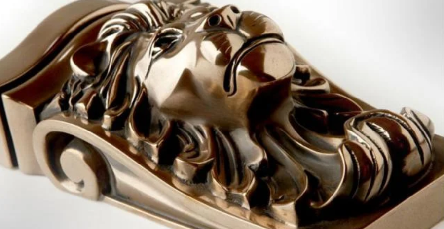 Polished bronze lion head corbel