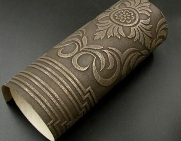Curved panel with floral relief in dark bronze finish