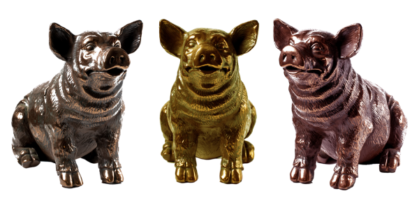 Three cold-cast pig figurines in bronze, brass, copper